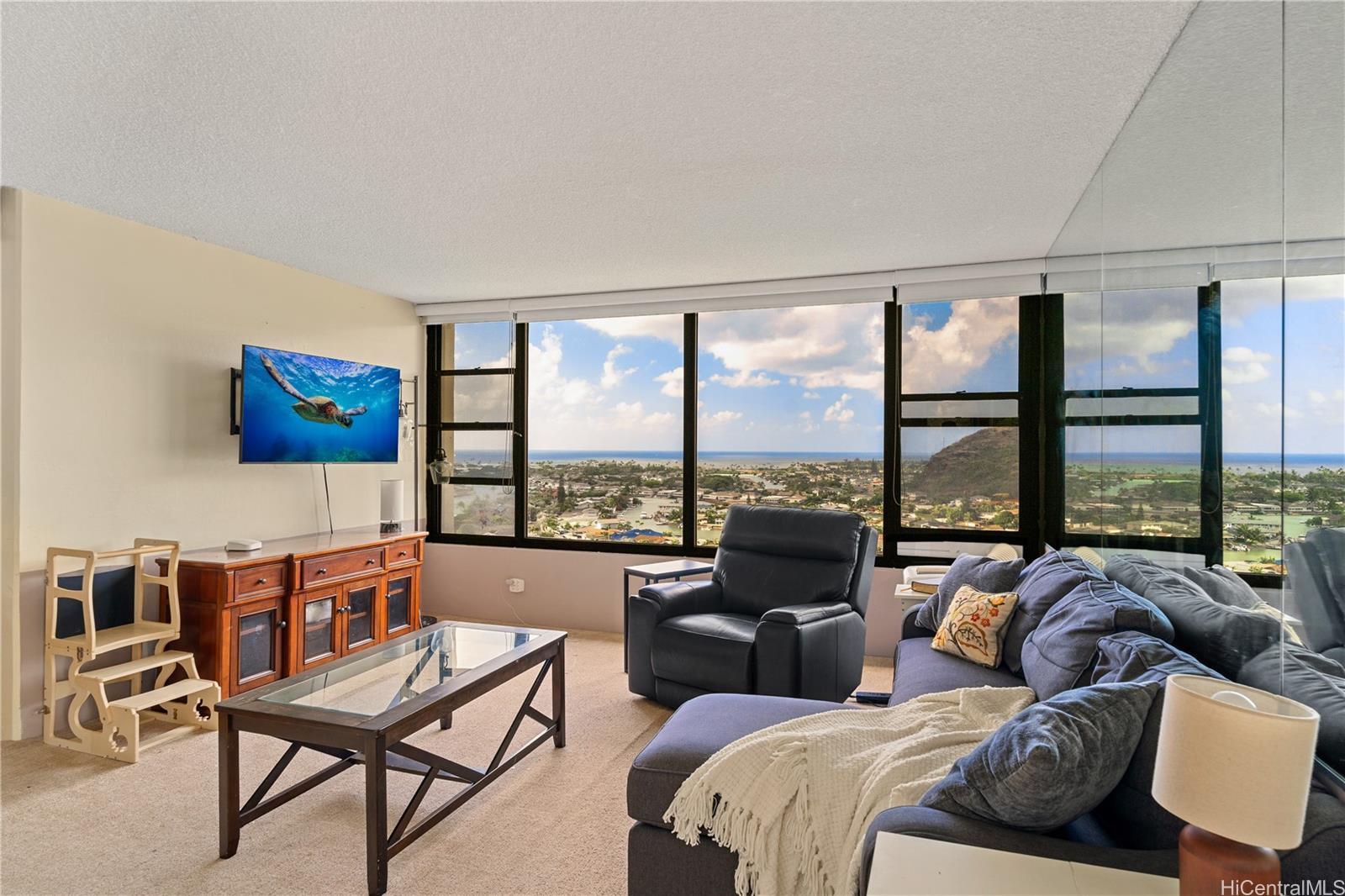 Living room with views of the marina, coastline, ocean and sunset