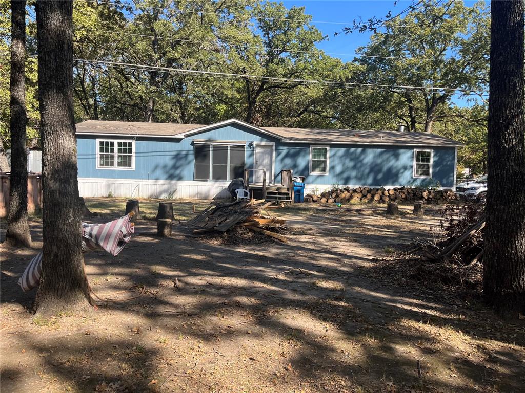 a front view of a house with yard porch and sitting area