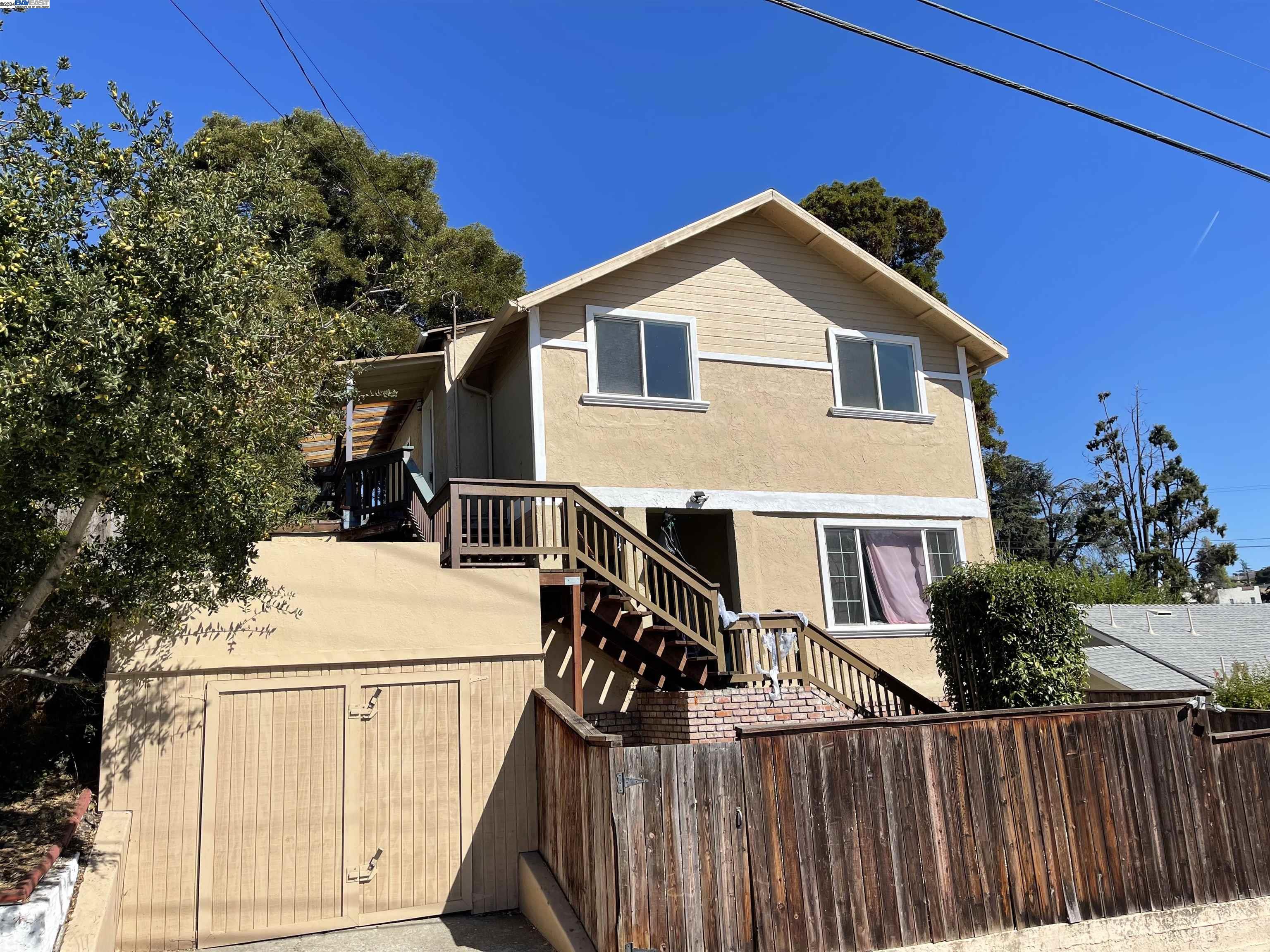 a view of a house with wooden fence