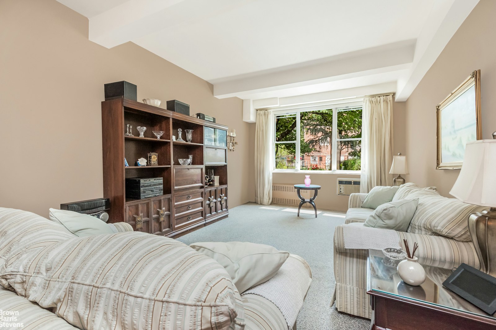 a bedroom with bed and a large window