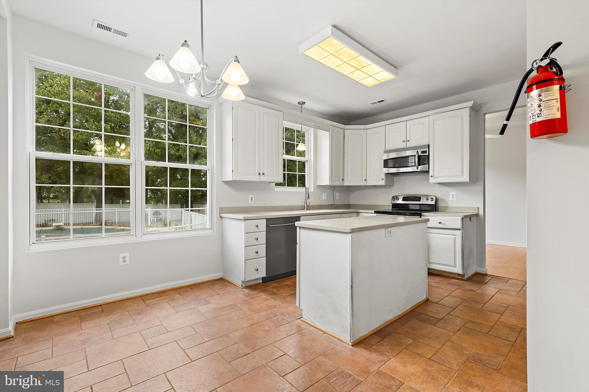 a kitchen with a refrigerator and a sink