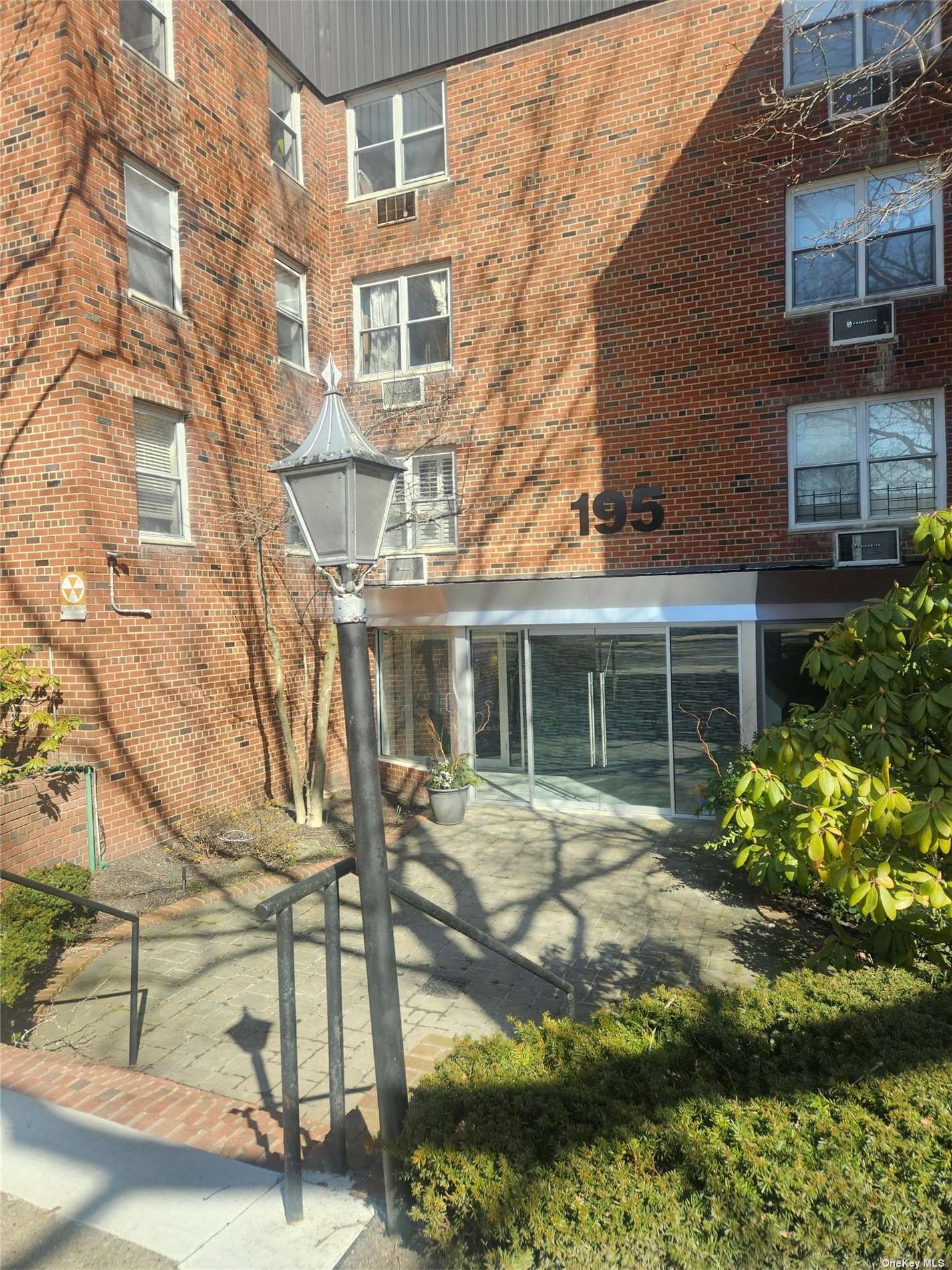 a view of a brick building next to a yard