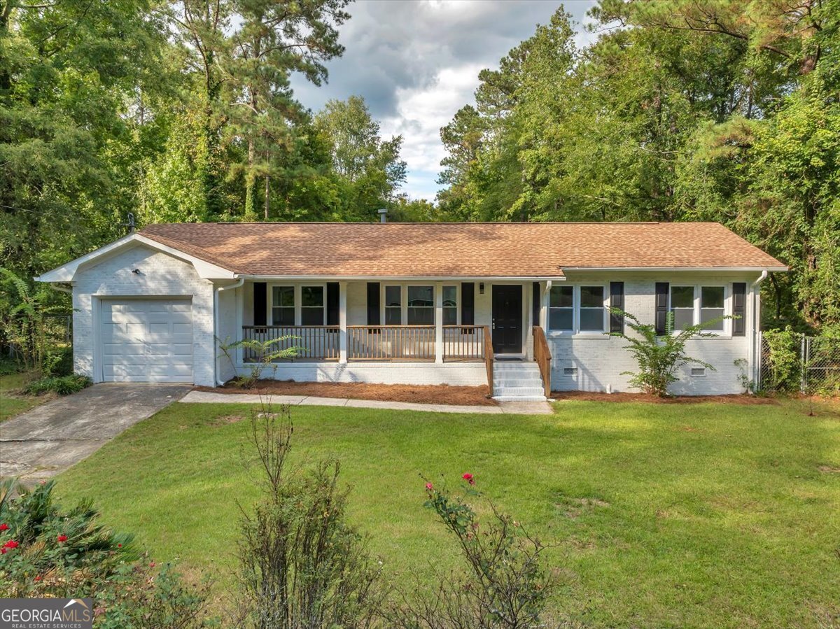 a front view of a house with a yard porch and patio