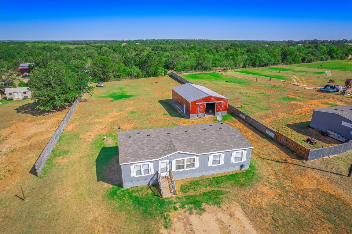 an aerial view of a house with garden space and street view