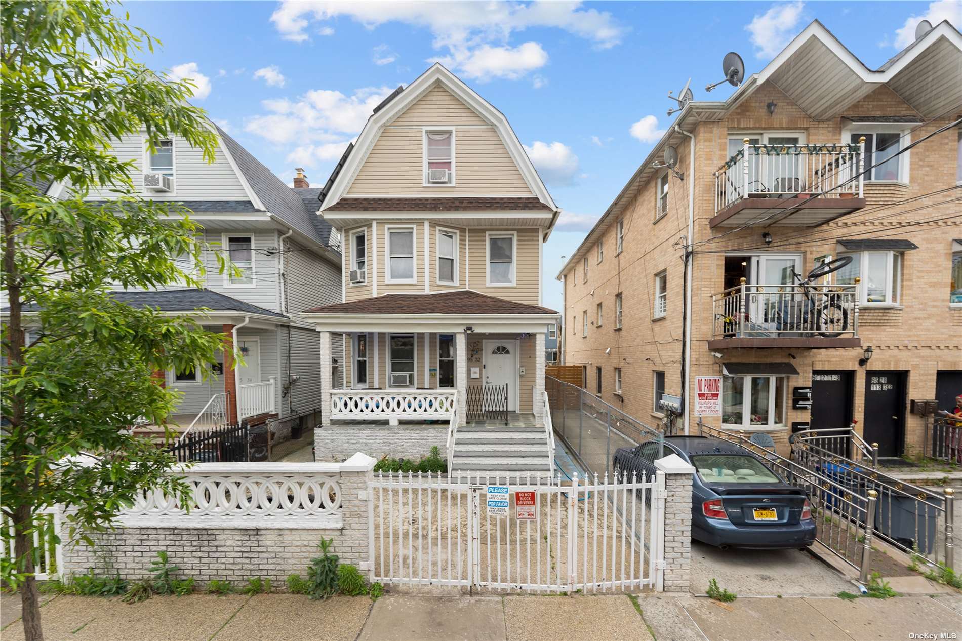 a front view of a residential apartment building with a yard