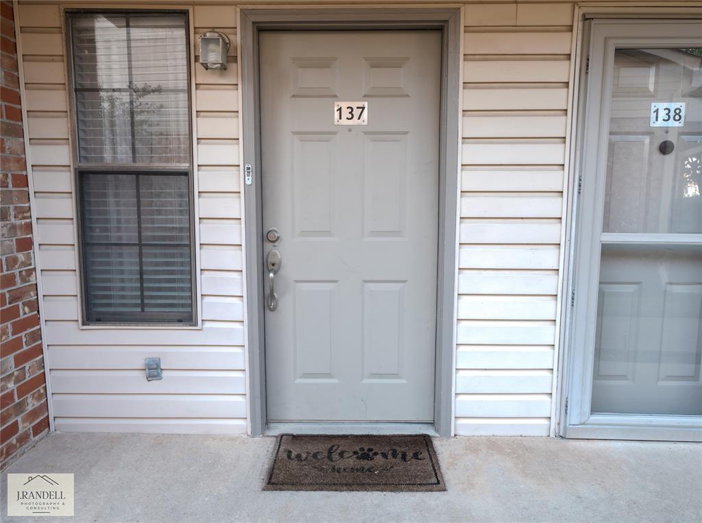 a view of a door and a window