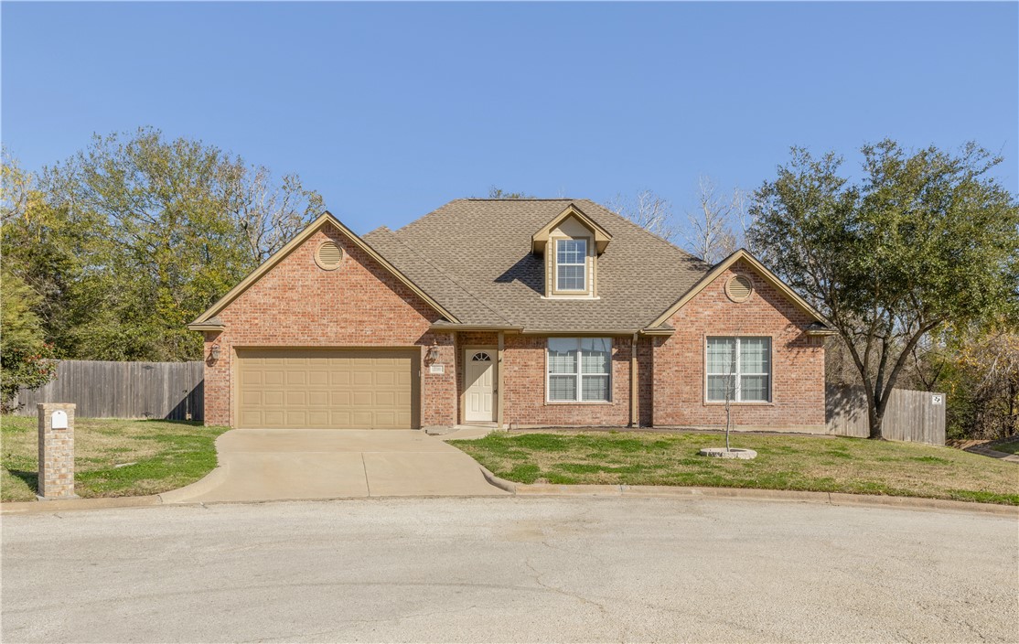 View of front of property featuring a garage and a