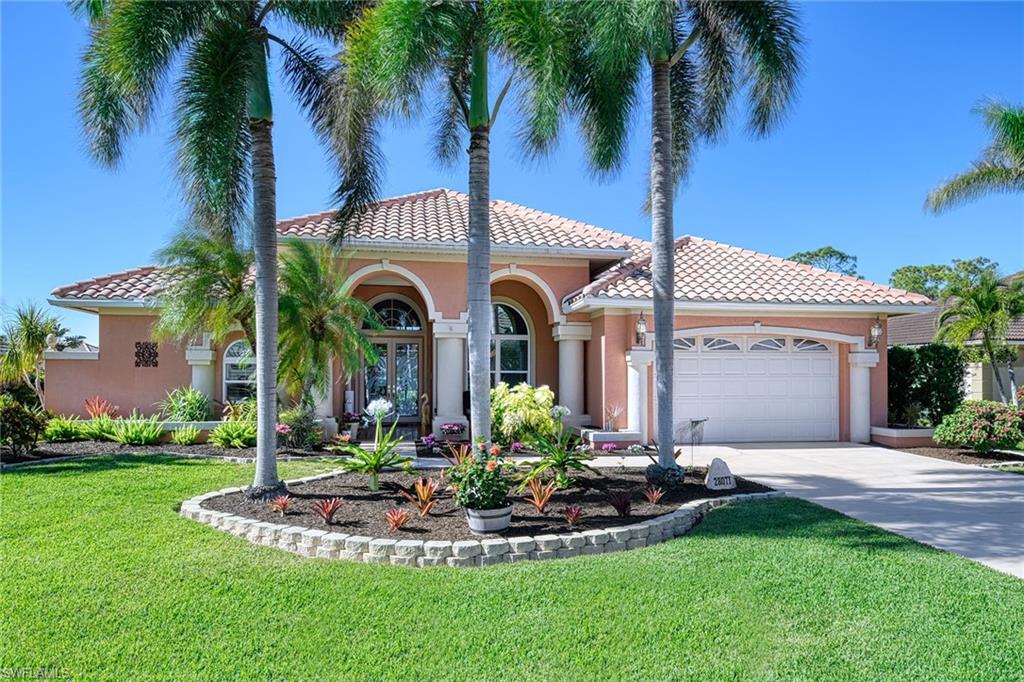 a front view of a house with a garden and plants