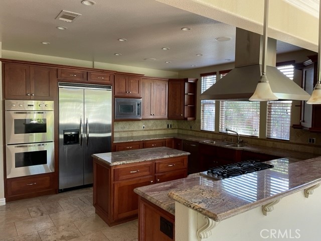 a kitchen with a stove and a refrigerator