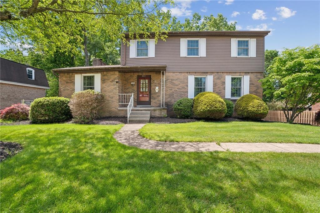 a front view of a house with a yard and plants