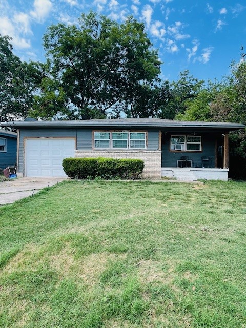 a front view of house with yard and trees in the background