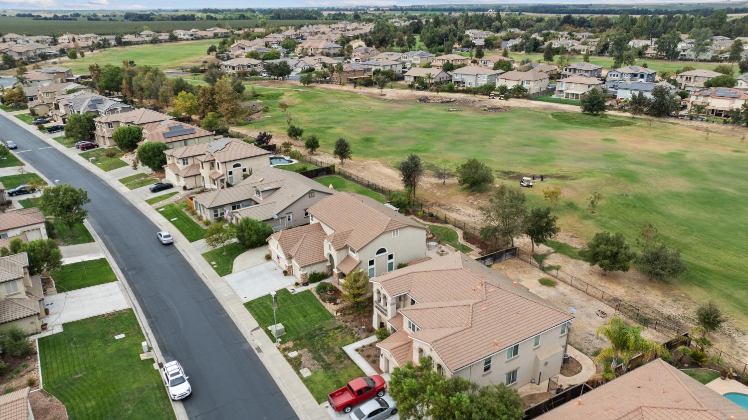 an aerial view of residential houses with outdoor space