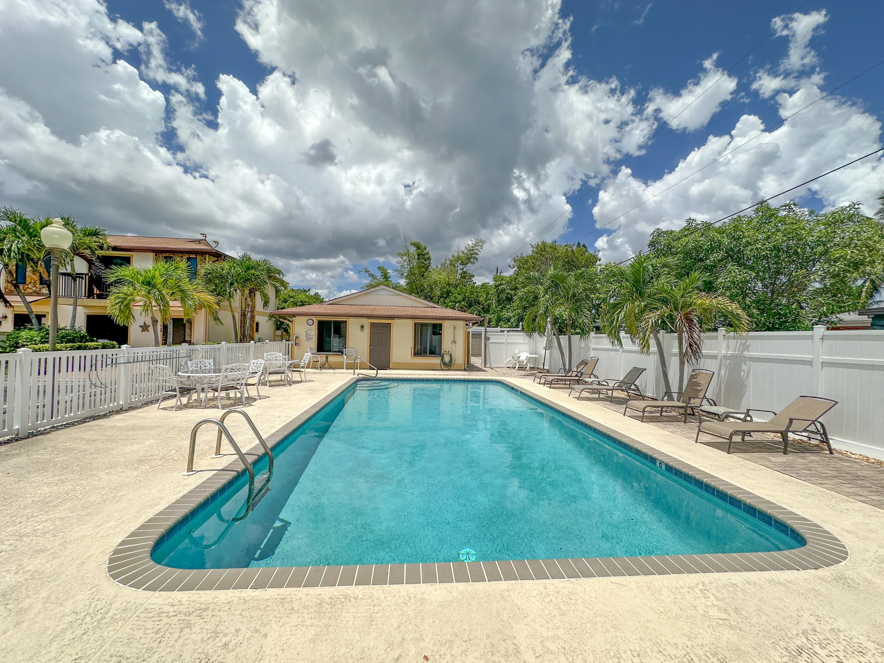 a view of a house with swimming pool and sitting area