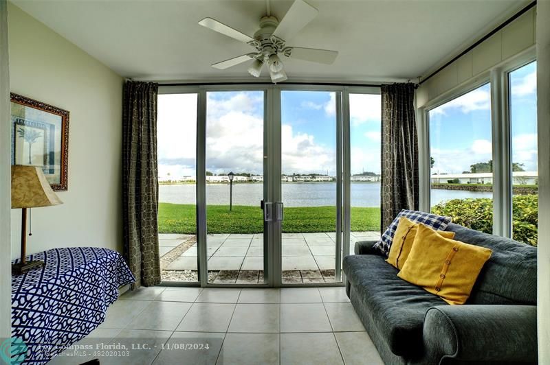 a living room with furniture and a floor to ceiling window