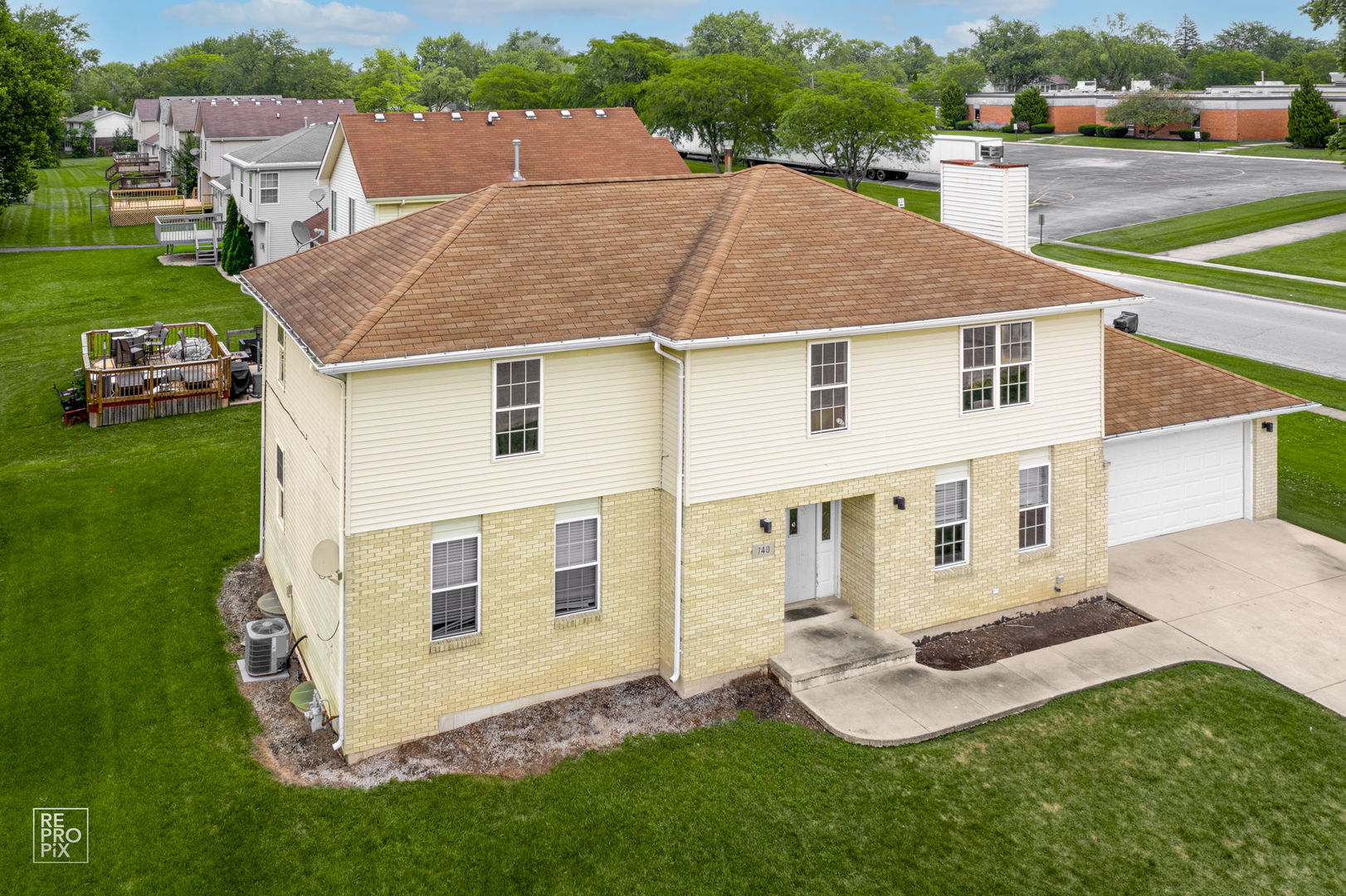 a aerial view of a house with a yard and sitting area