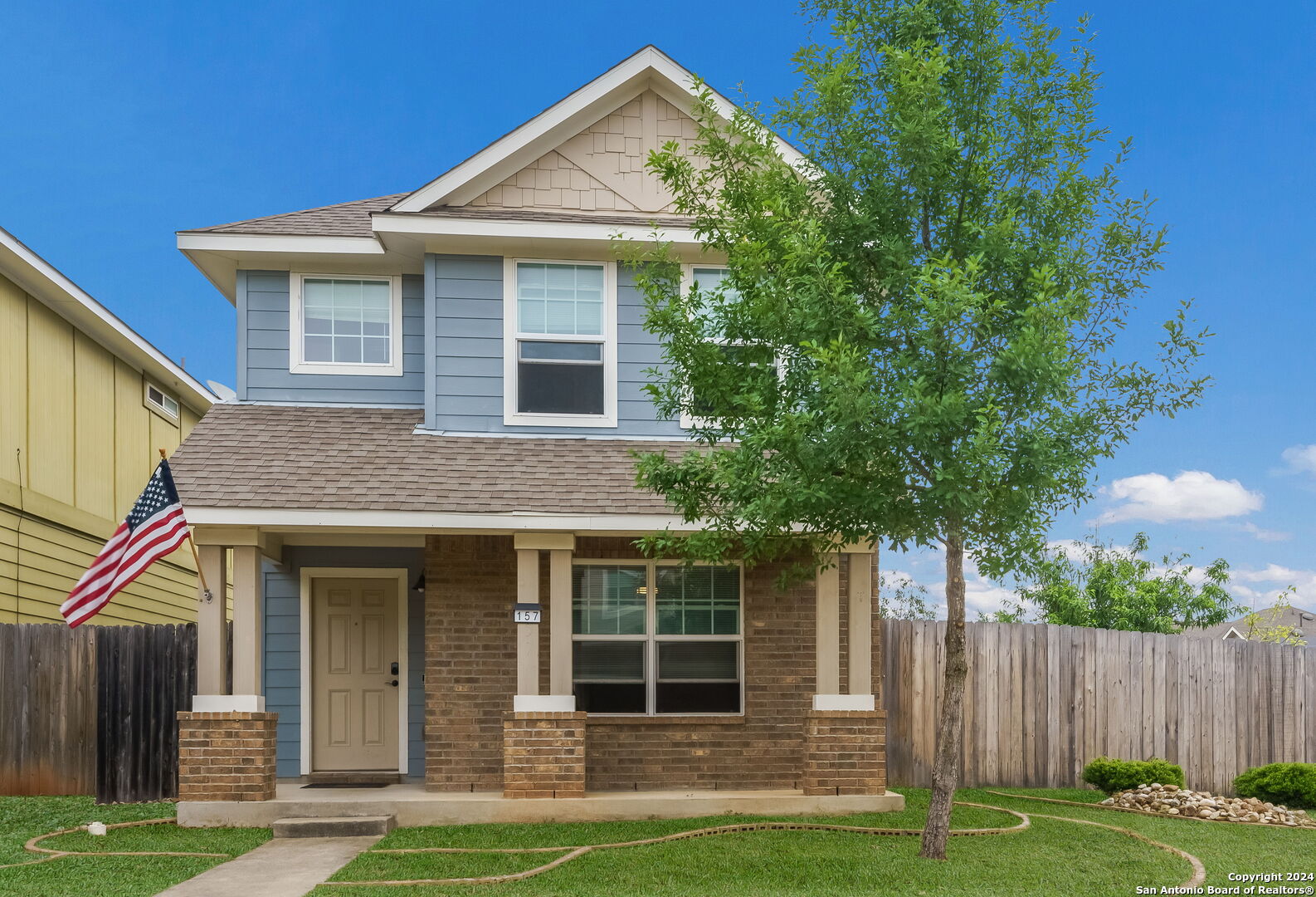 a front view of a house with a yard