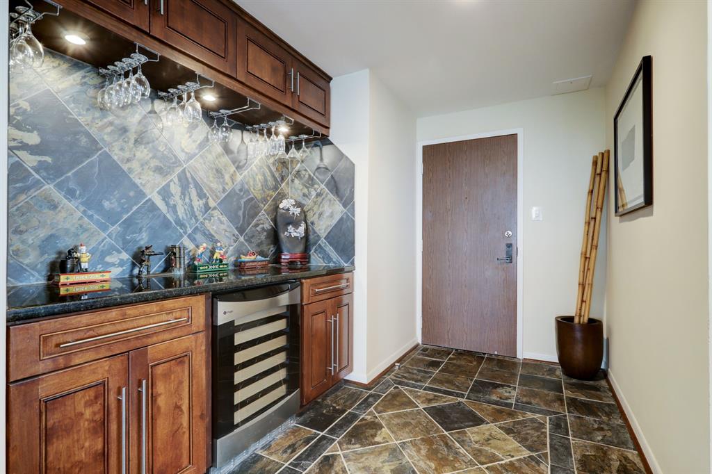 Entry hall with built-in bar area makes for entertaining ease.