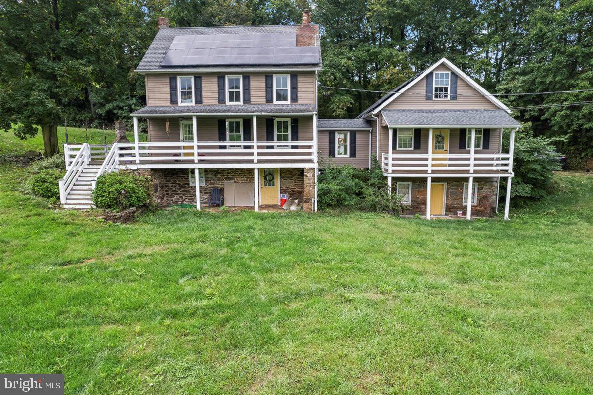 a front view of a house with a yard and trees