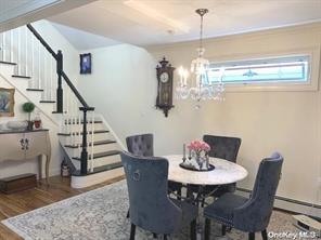 a view of a dining room with furniture wooden floor and chandelier