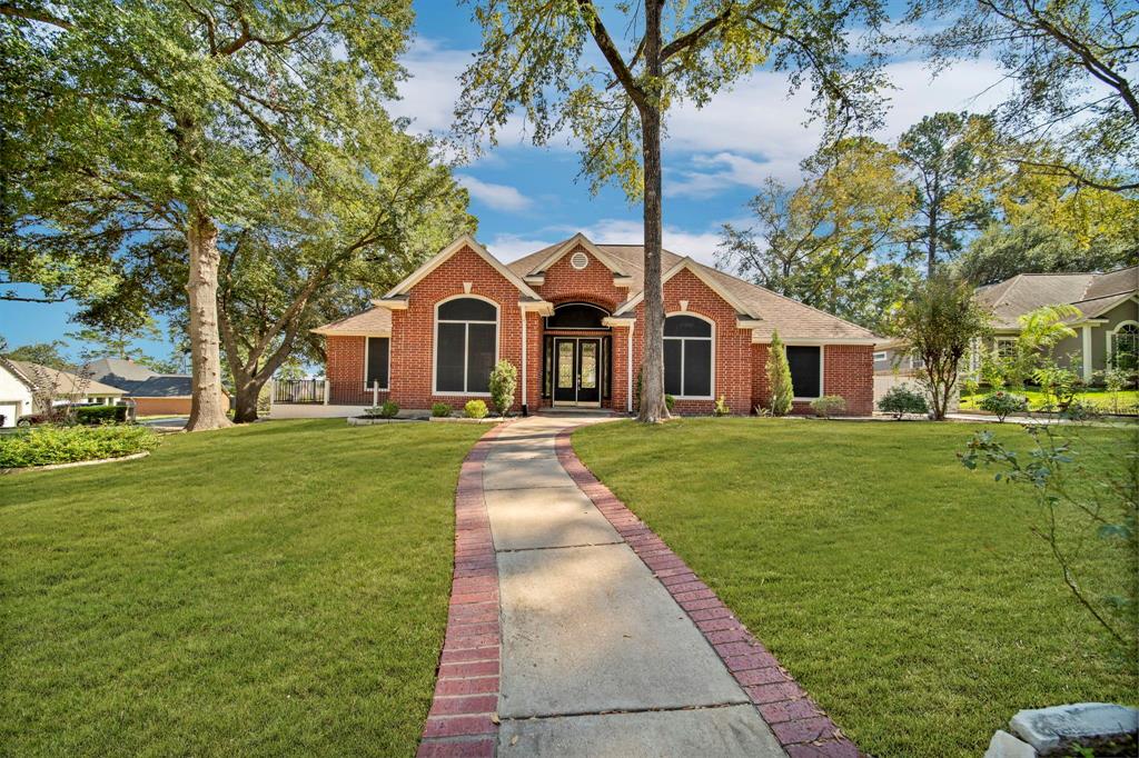 a front view of a house with a garden and trees