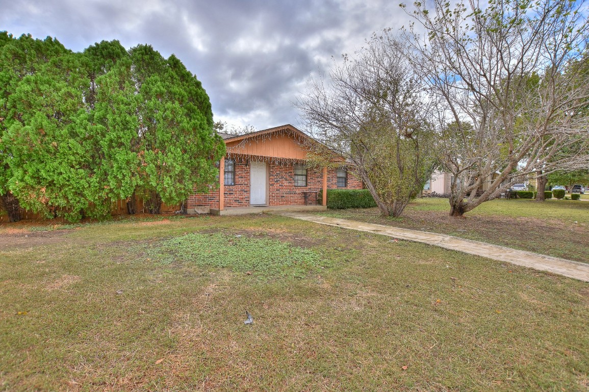 a view of a house with a yard and garage