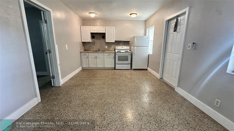 a view of kitchen with refrigerator stove microwave and cabinets