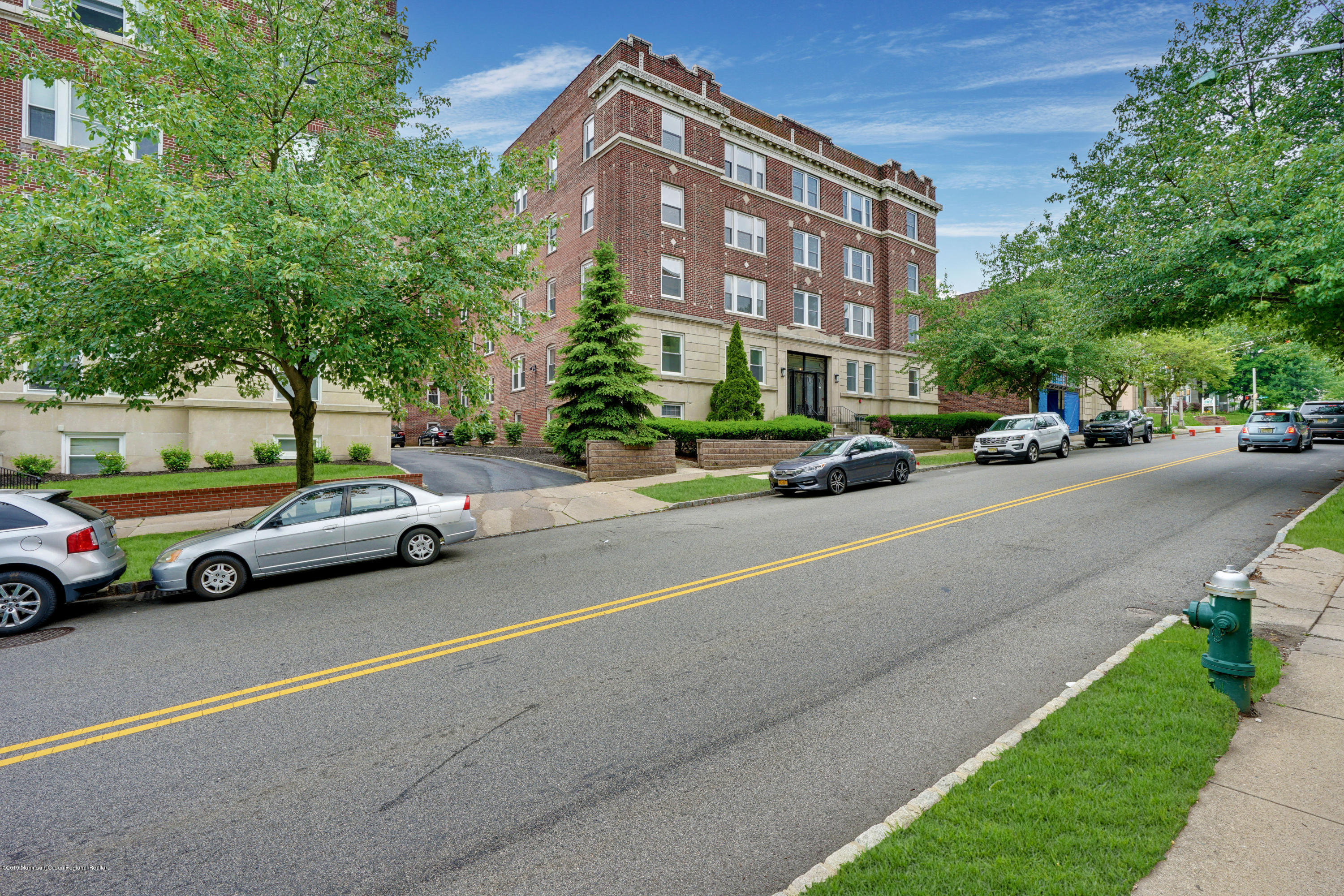 a view of street with parked cars