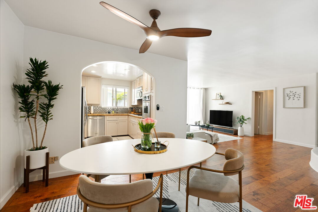 a view of a dining room with furniture and wooden floor