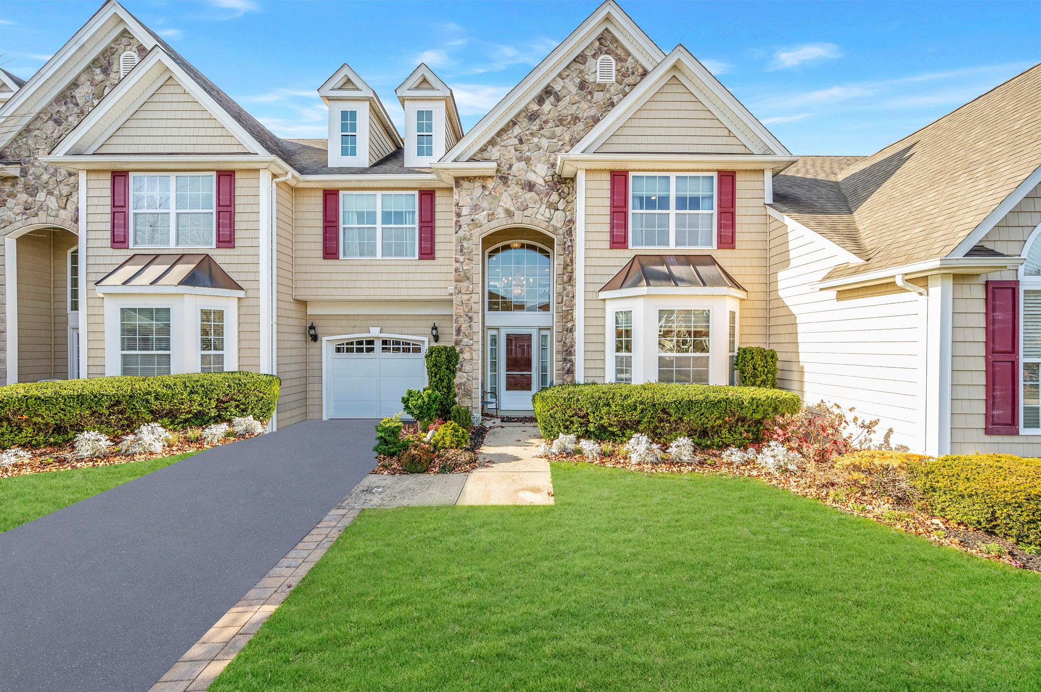 View of front of house with a front yard and a garage