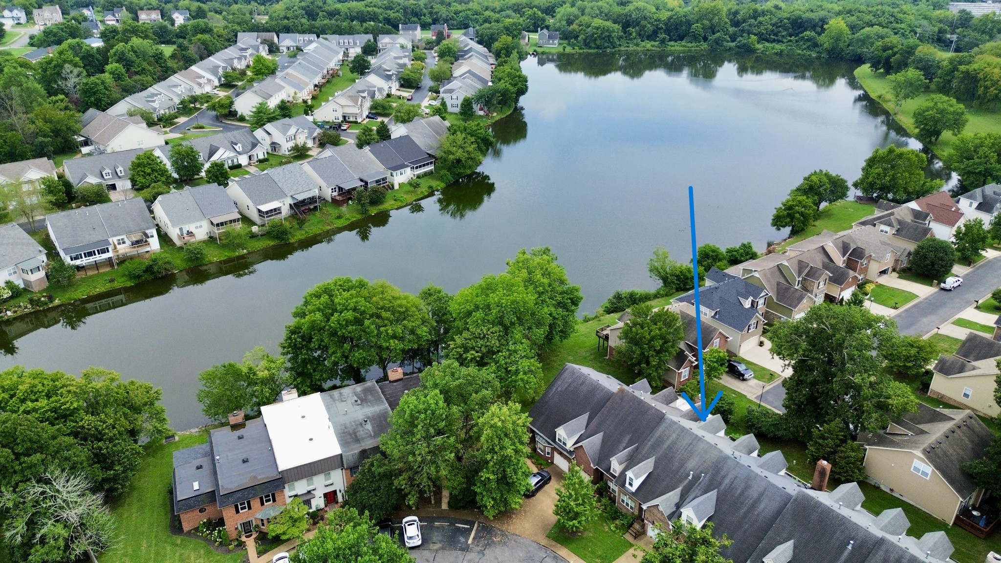 an aerial view of house with yard and lake view