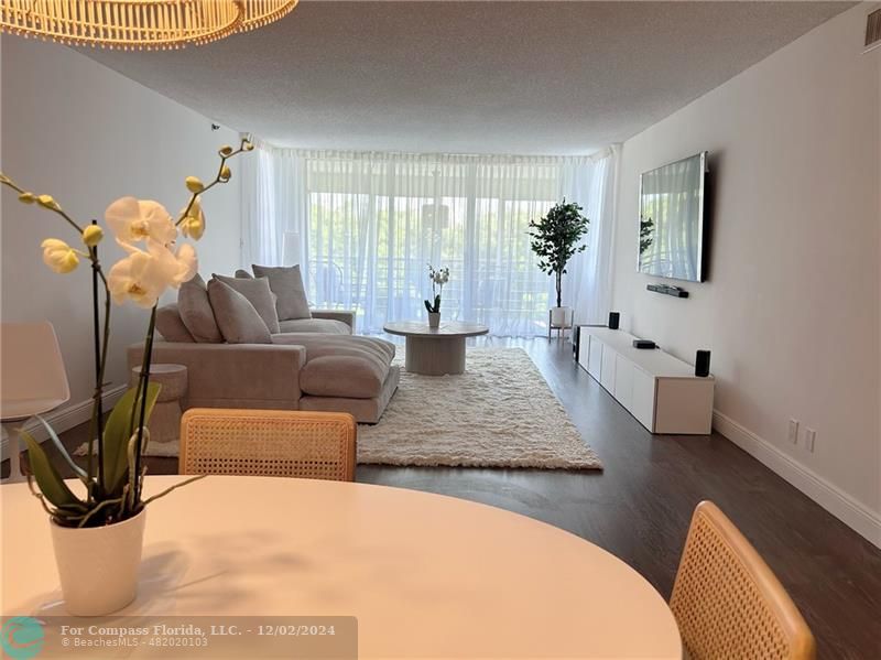 a living room with furniture flowerpot and a window