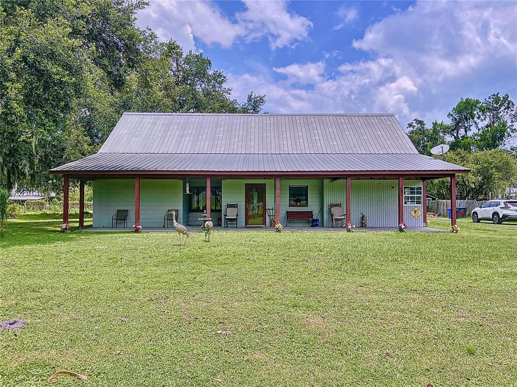 a front view of a house with a garden and porch