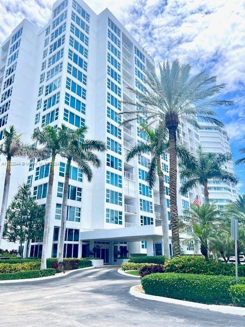 a view of a tall building next to a yard