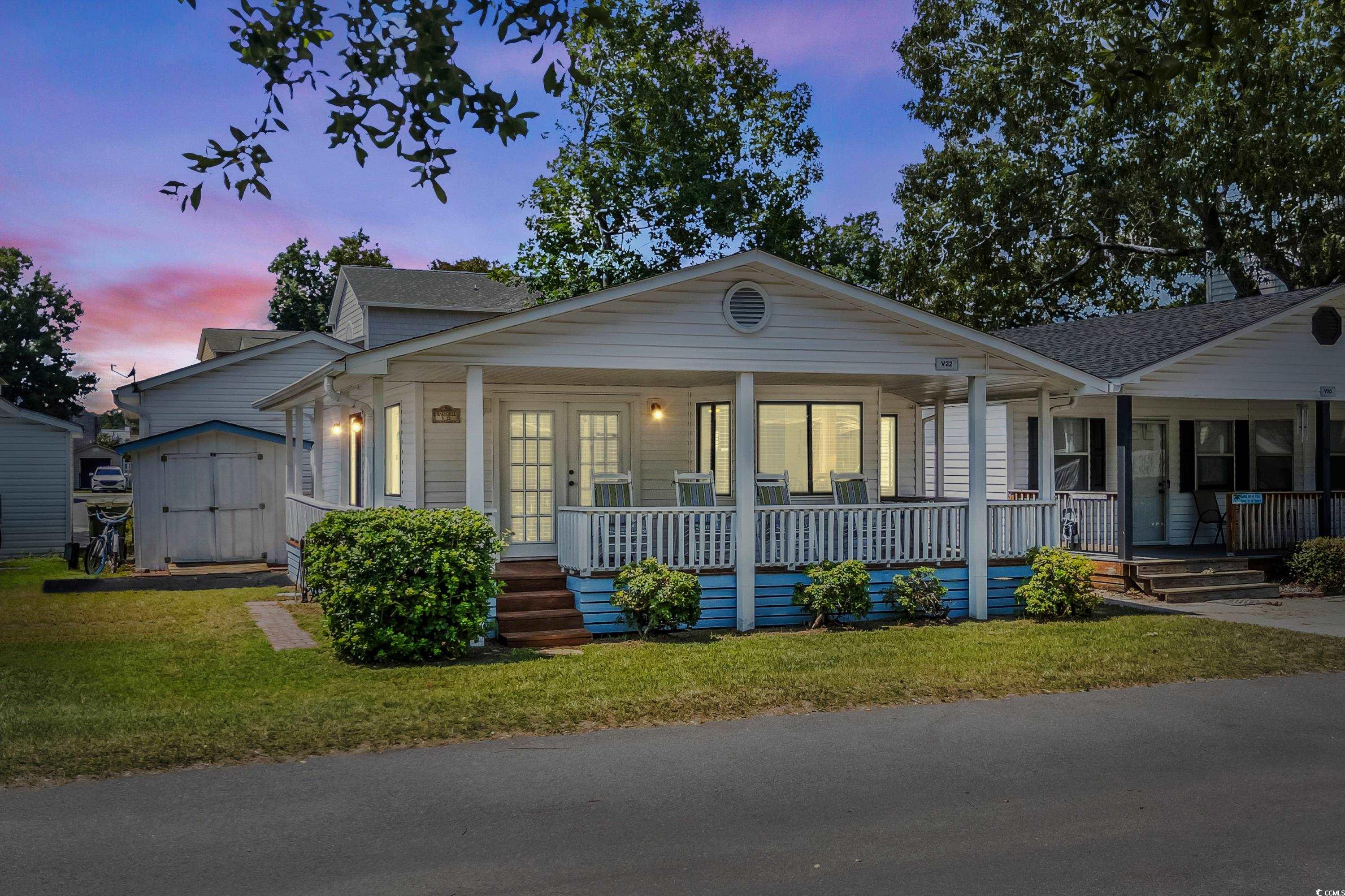 View of front of house featuring a lawn, covered p