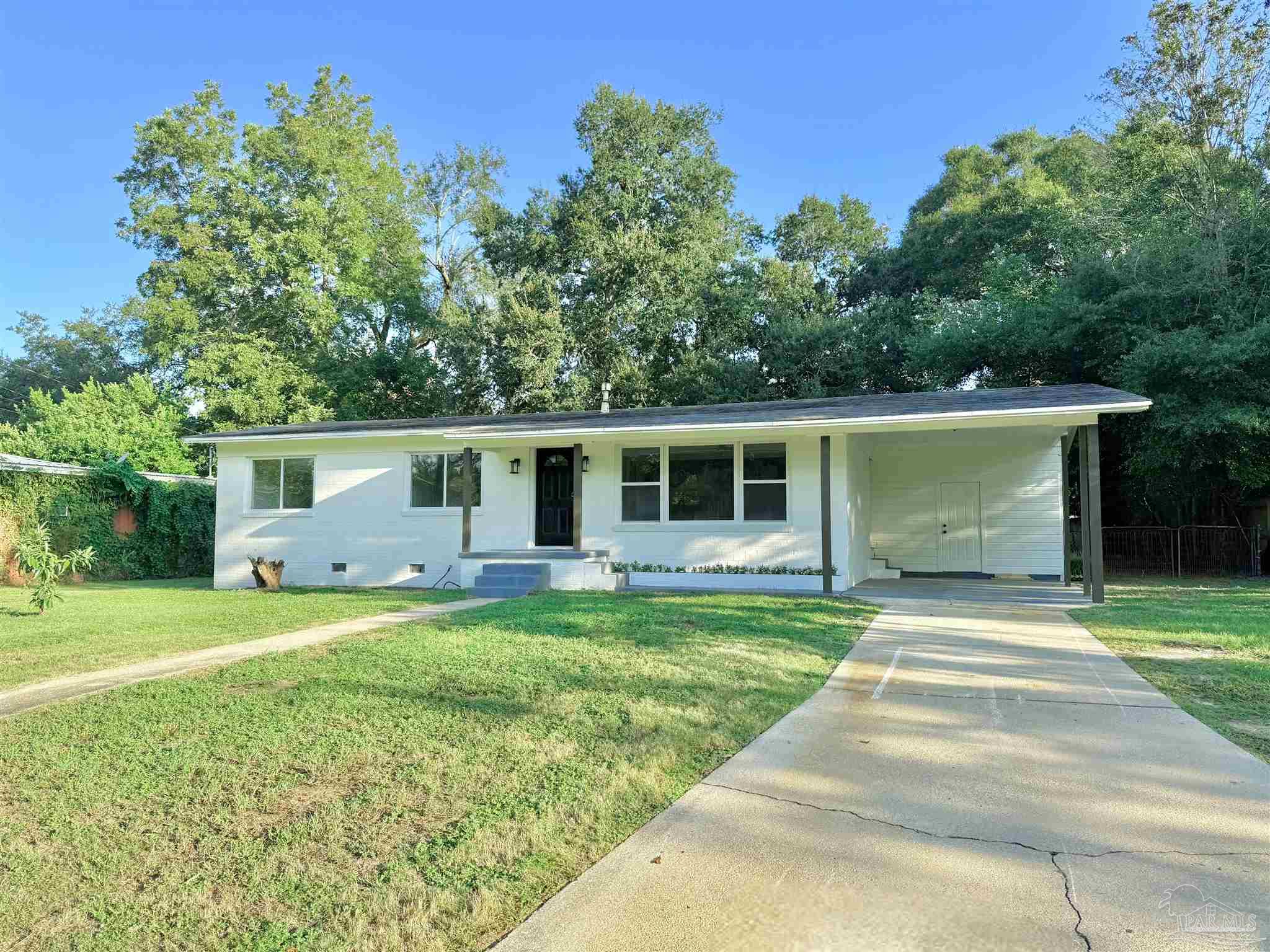 a front view of a house with a yard and porch