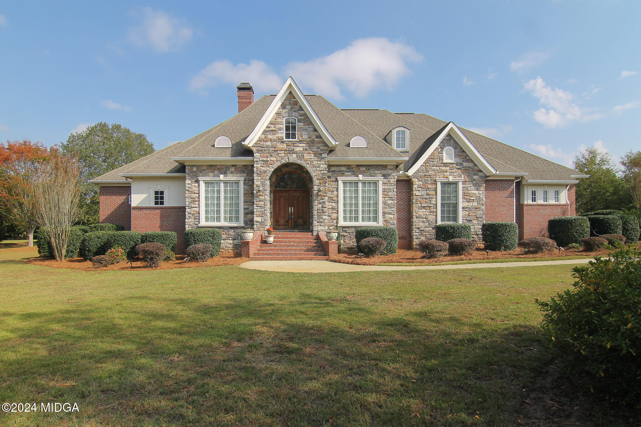 a front view of a house with a yard