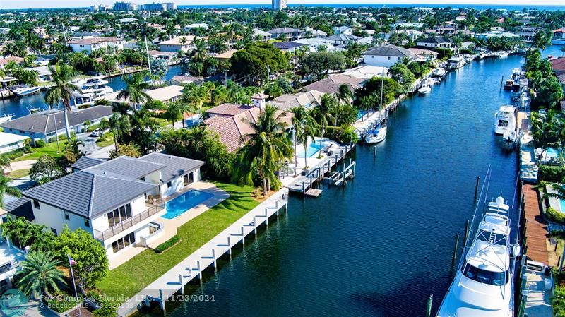 an aerial view of residential houses with outdoor space and swimming pool