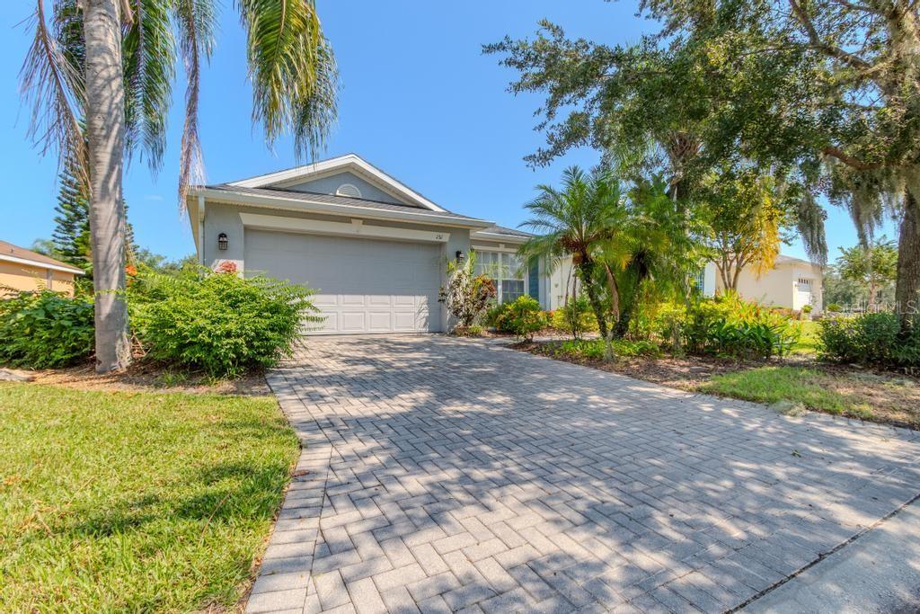 a front view of a house with a yard and a garage