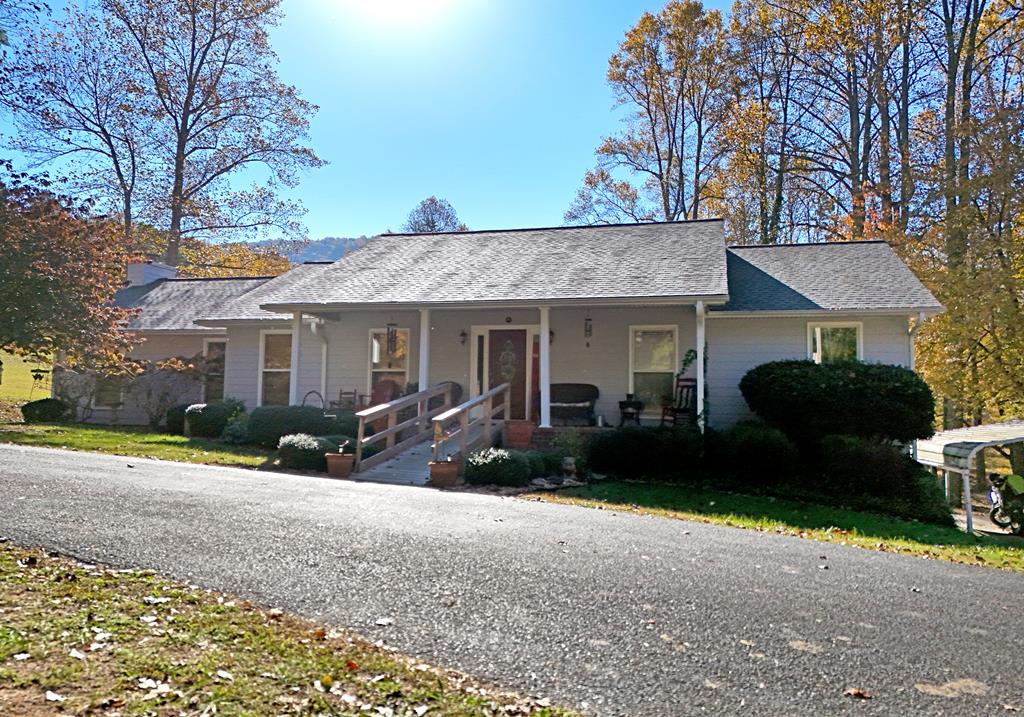 a front view of a house with a yard and garden