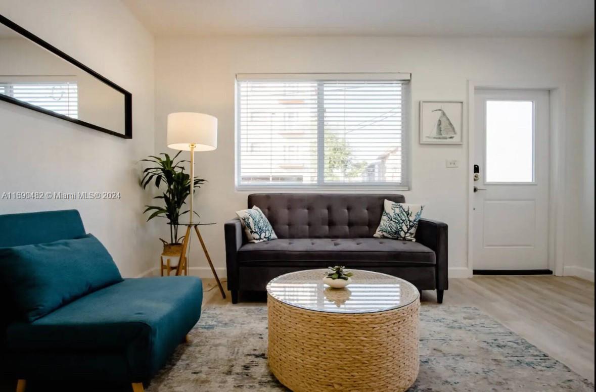 a living room with furniture and a potted plant