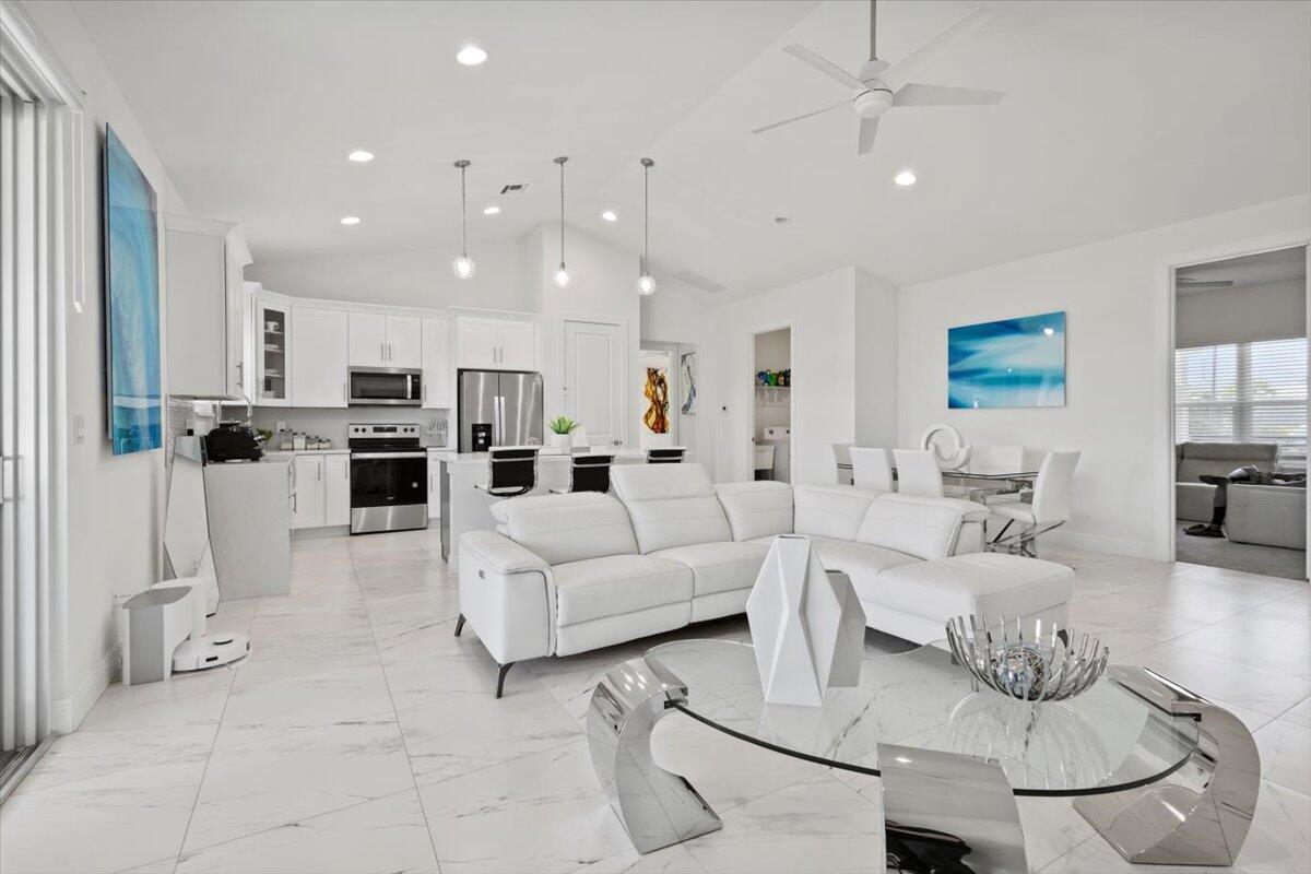 a living room with furniture and kitchen view