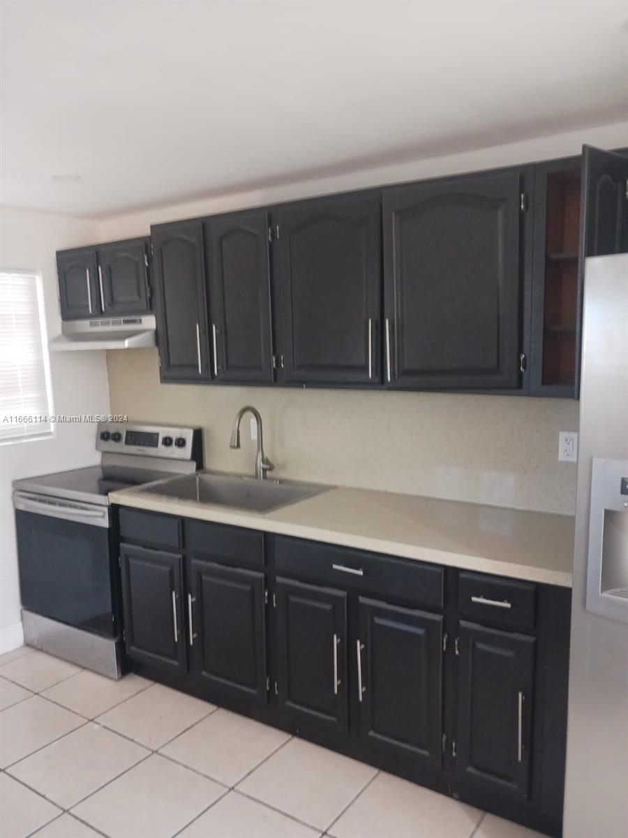 a kitchen with a sink and cabinets