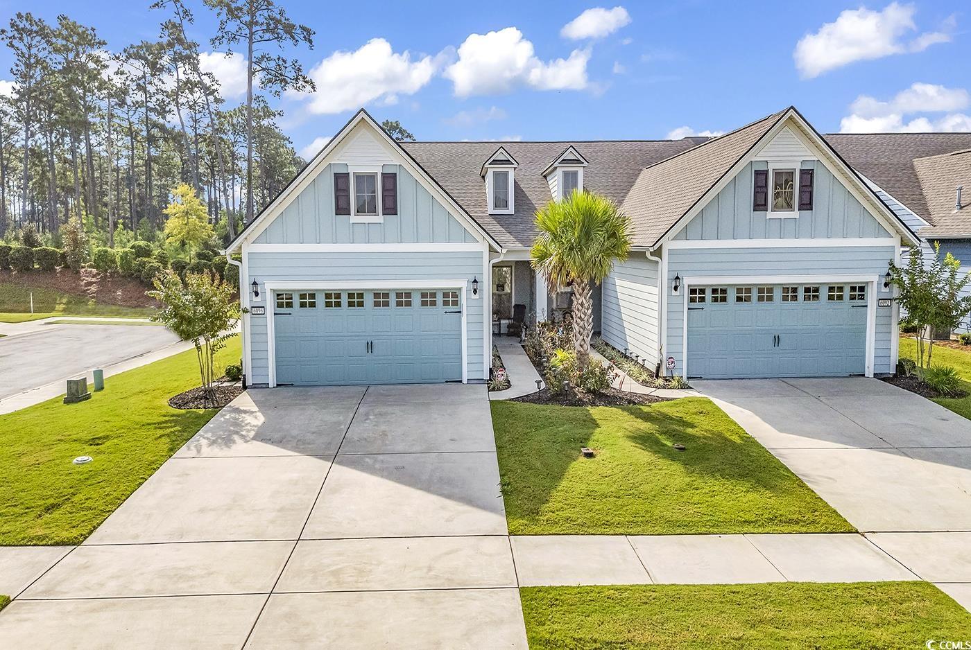 Craftsman-style home featuring a garage and a fron