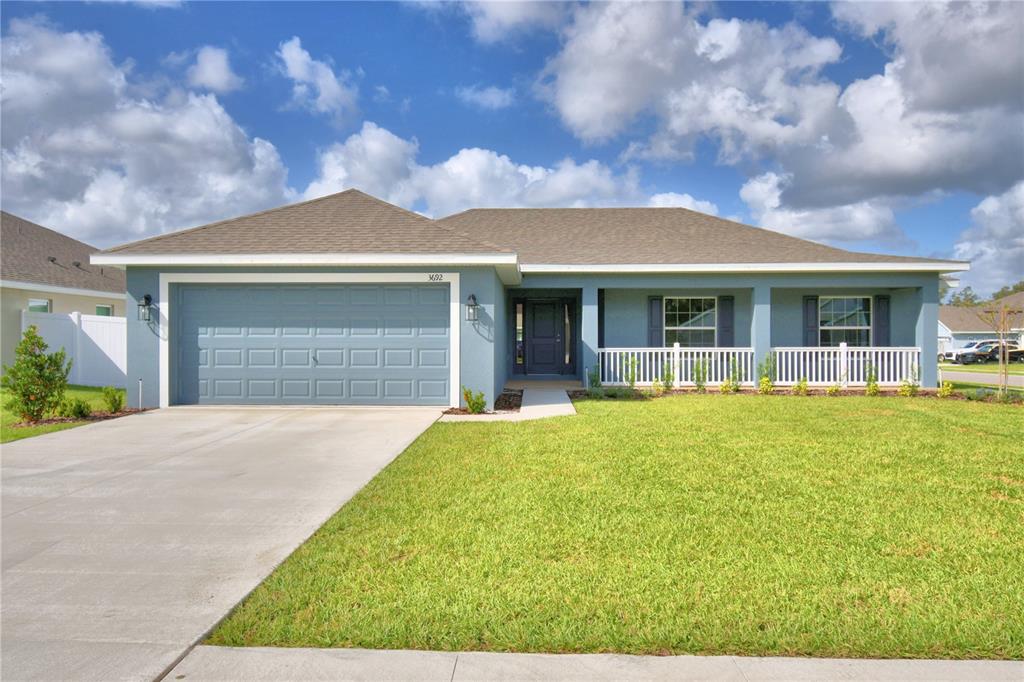 a front view of house with yard and green space