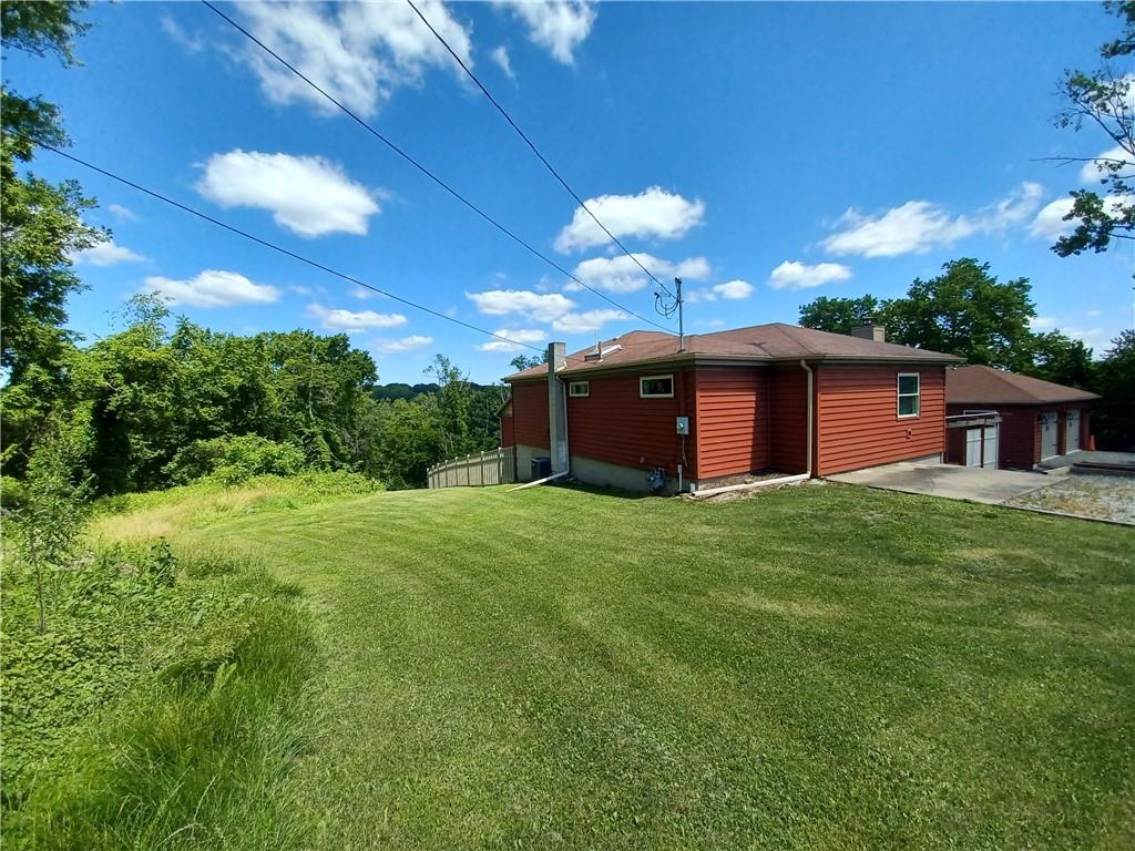 a view of a house with a backyard