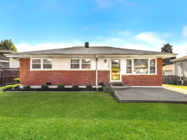 a front view of house with yard and green space