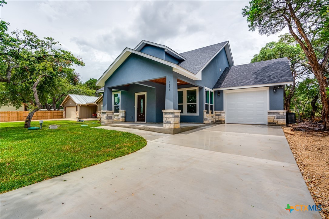 a view of a house with a yard and tree s