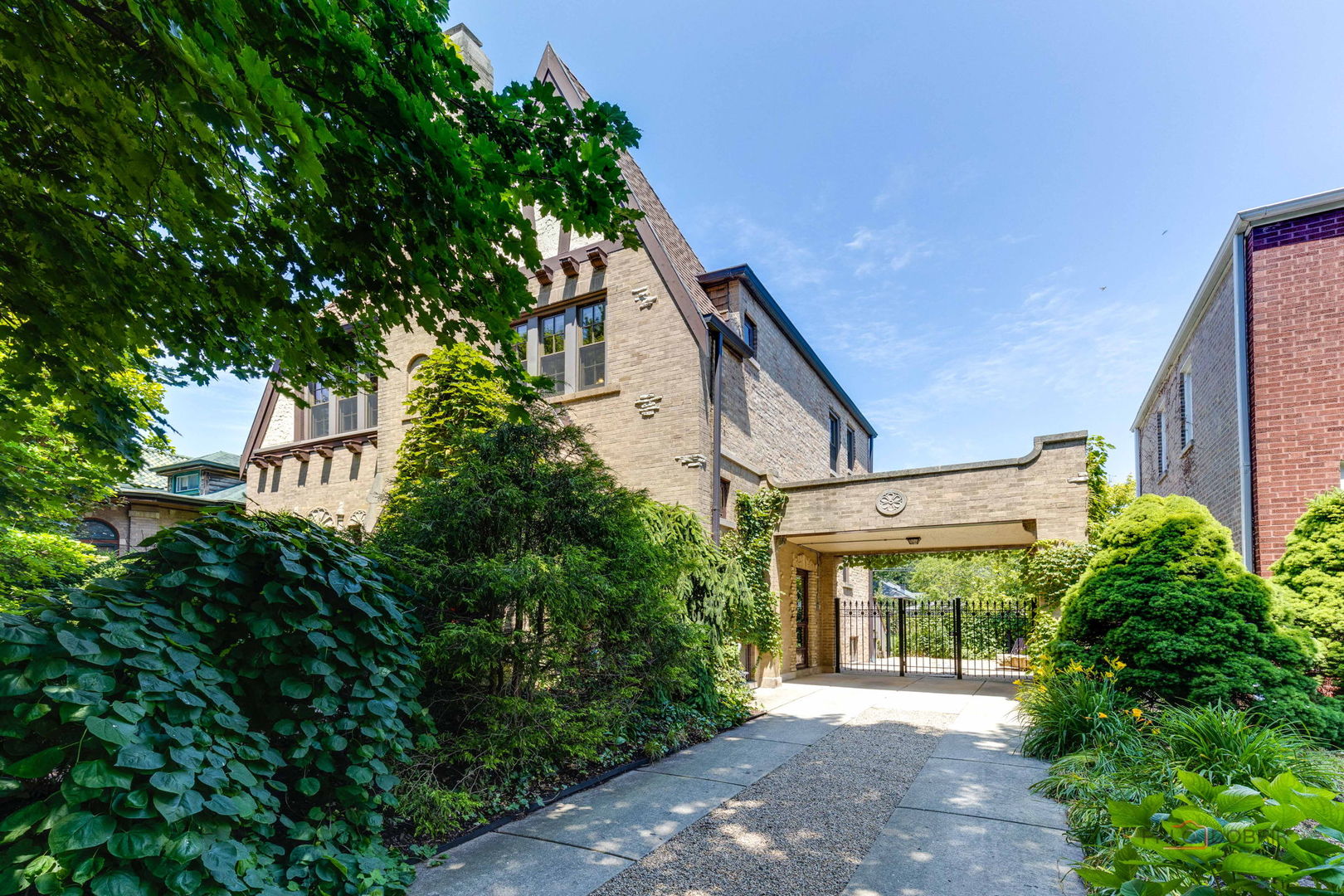 a front view of a house with a garden