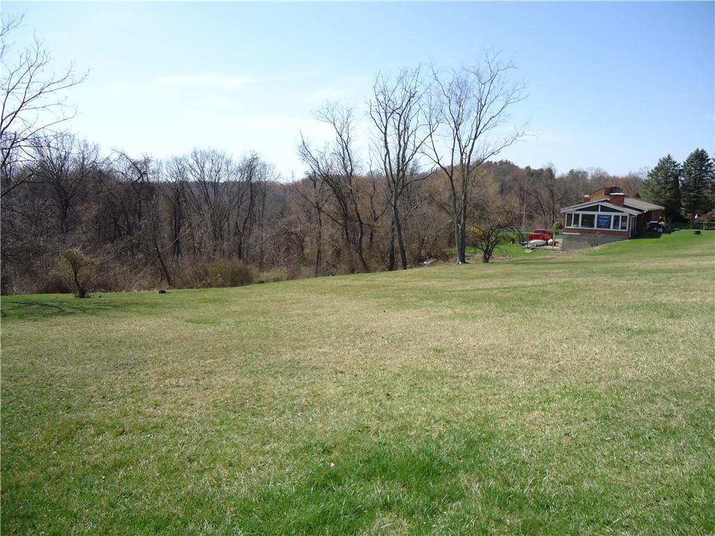 a view of outdoor space with green field and trees