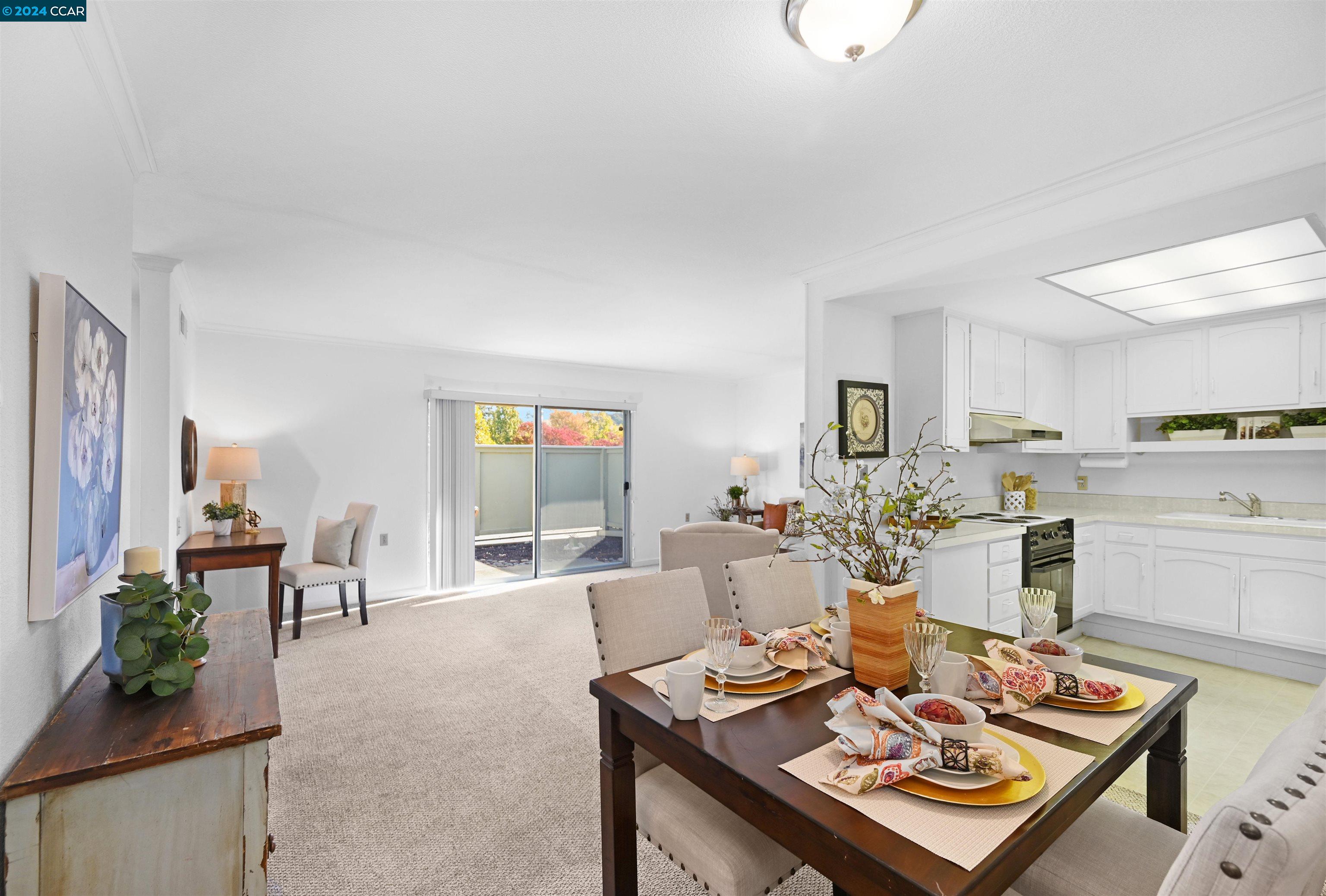 a living room with kitchen island furniture and a dining table